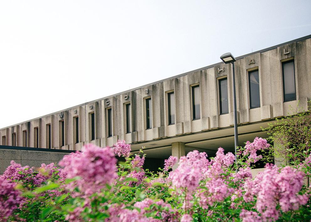 Wescoe Hall with pink flowers in Spring time